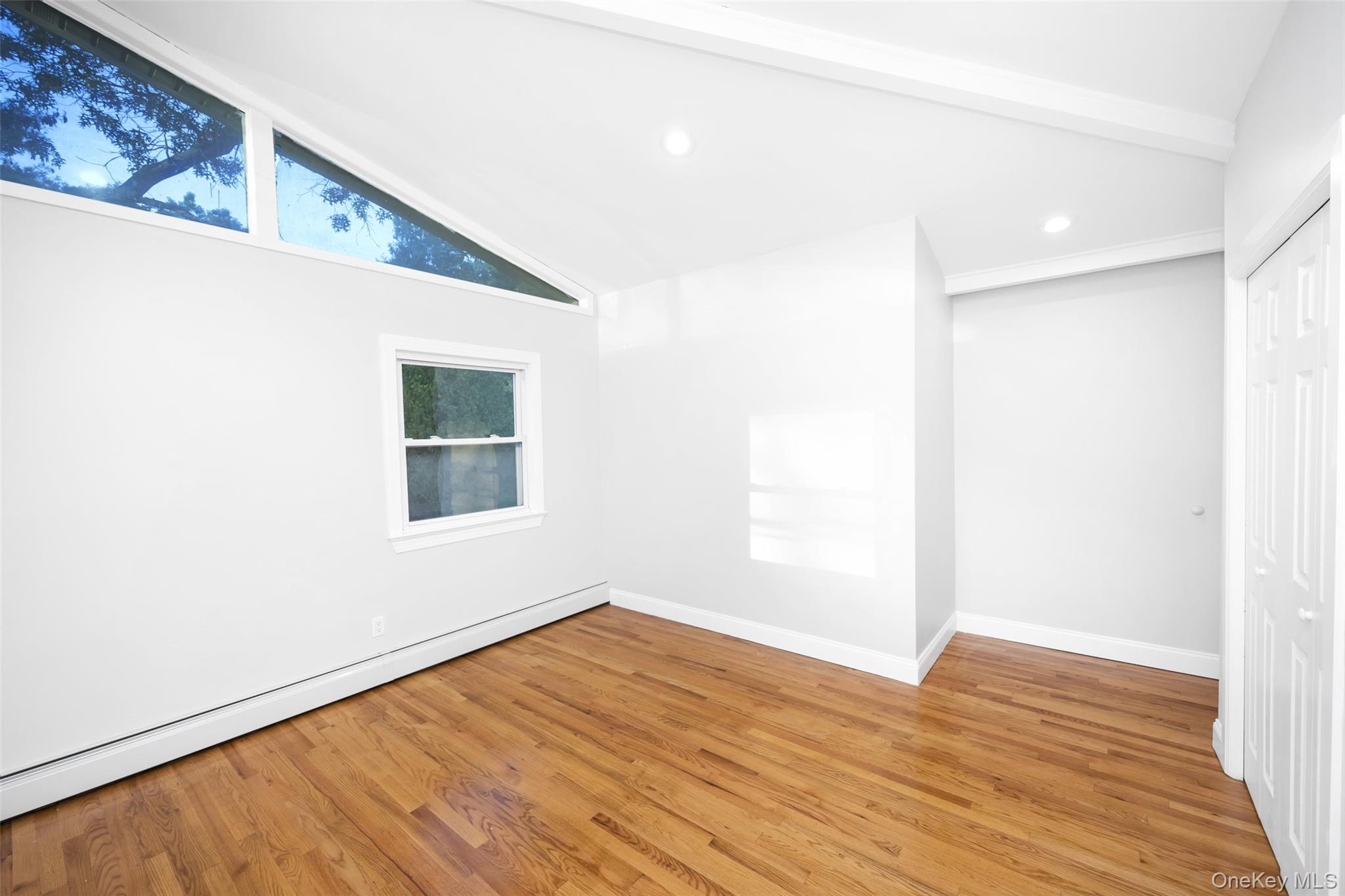 36 Red Spring Lane Glen Cove, NY 11542 - Photo 19 of 33 lofted ceiling, a baseboard radiator, light wood-type flooring, recessed lighting, and a closet