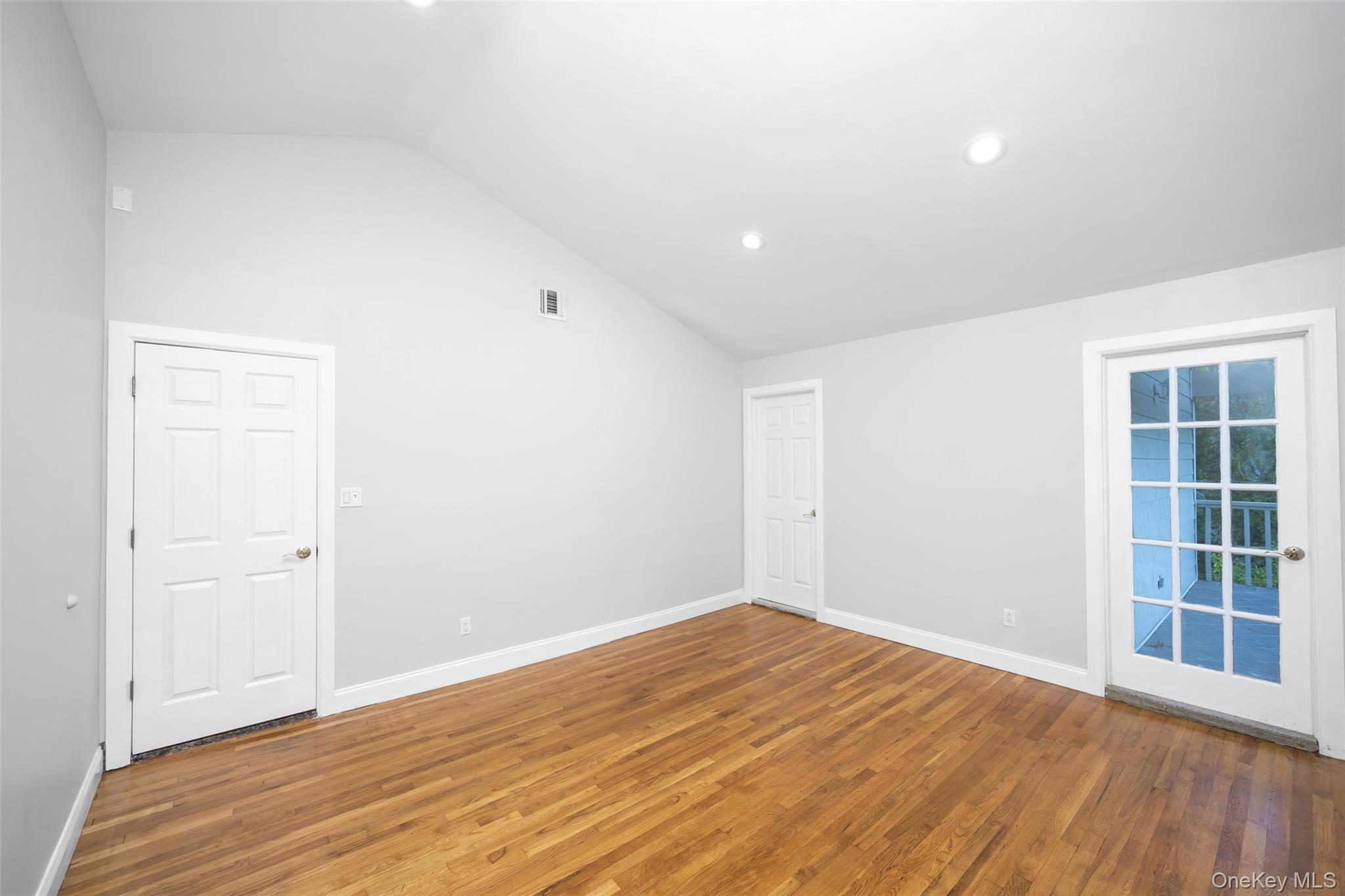 36 Red Spring Lane Glen Cove, NY 11542 - Photo 20 of 33 Primary bedroom (alternate view) – Additional angle showcasing the ensuite entry and seamless flow between the bedroom and bathroom.