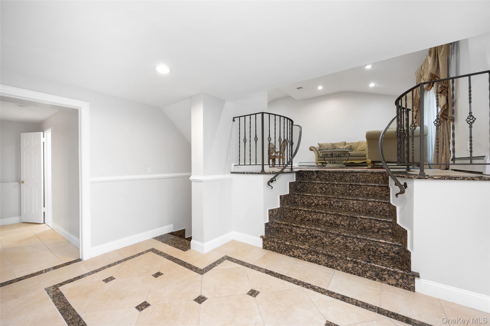 36 Red Spring Lane Glen Cove, NY 11542 - Photo 10 of 33 Entryway – Inviting foyer with custom tile inlay and granite steps leading to the main living area. Wrought iron accents provide an elegant transition between levels.
