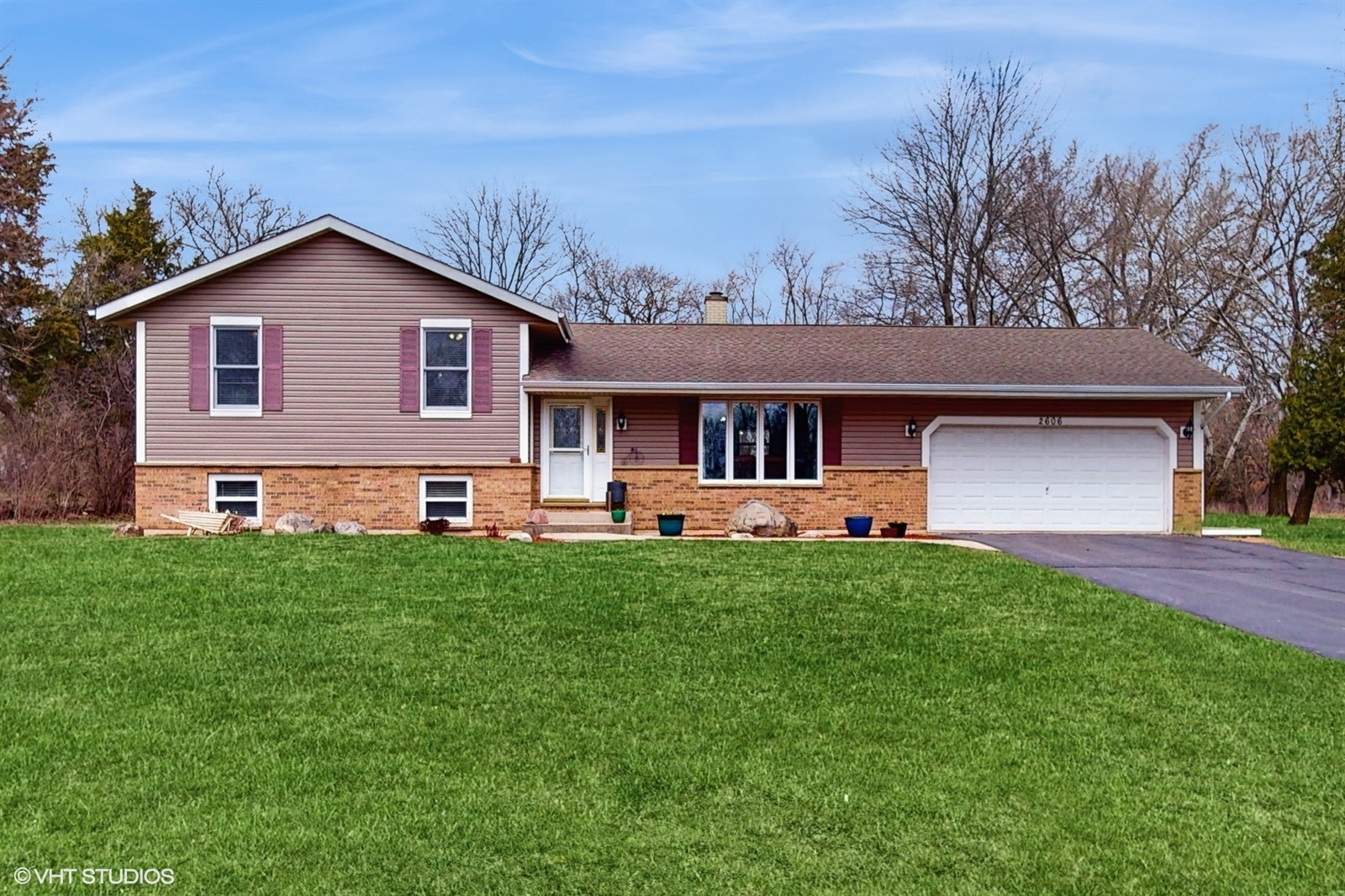 a front view of house with yard and green space