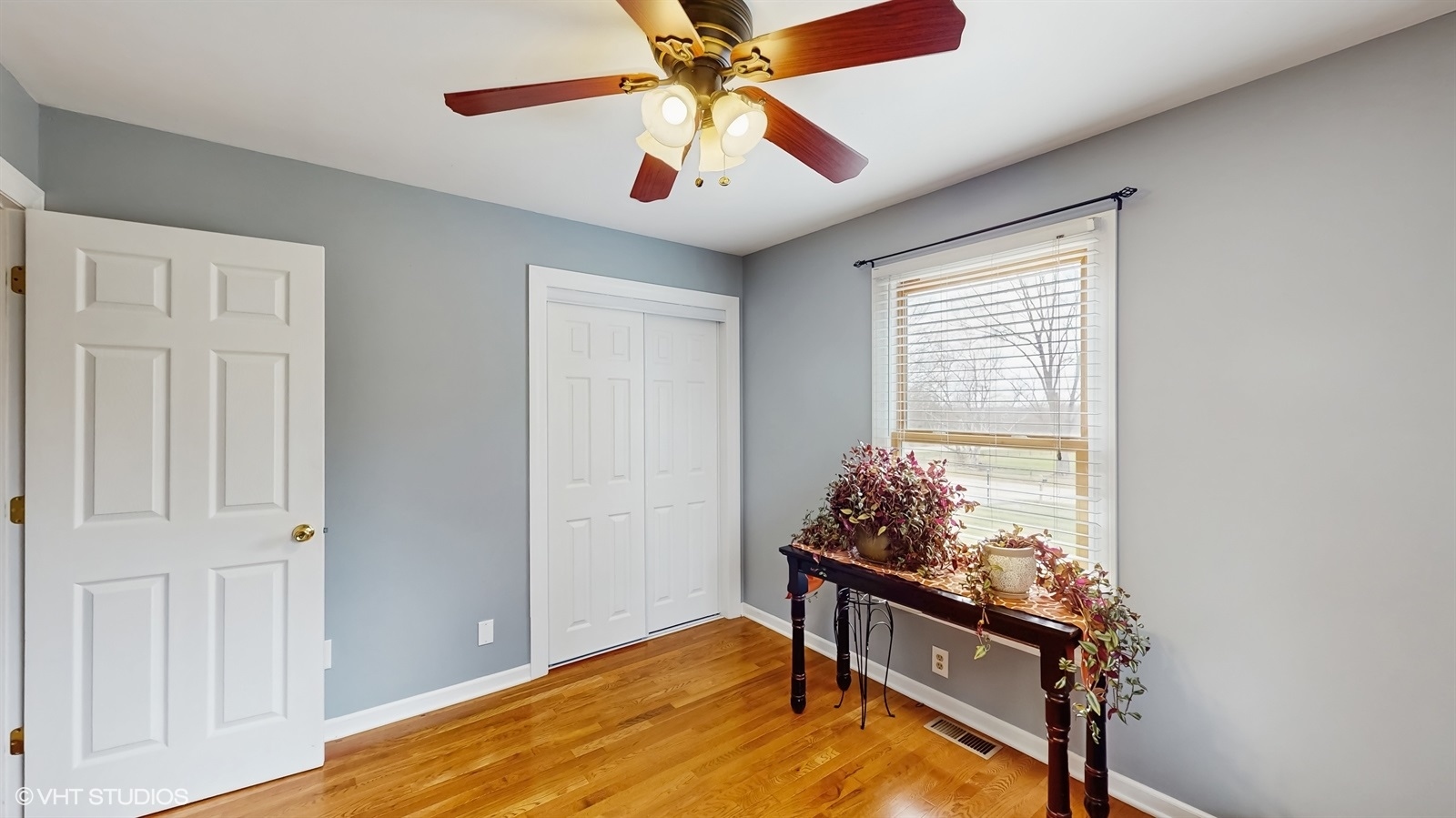2606 Martin Drive Spring Grove, IL 60081 - Photo 9 of 32 an empty room with wooden floor fan and windows