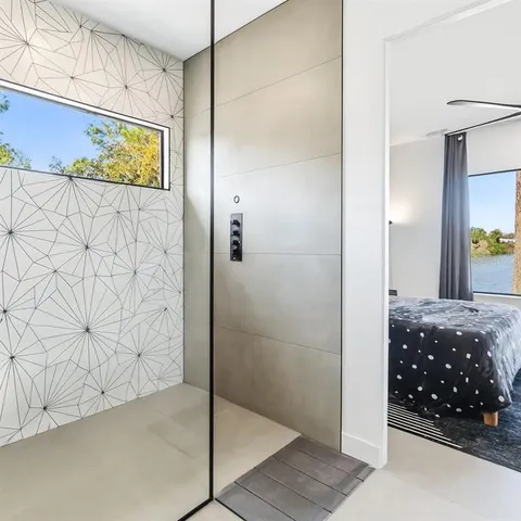 a bathroom with a shower and a sink