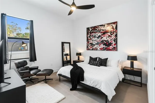 a bedroom with a bed a couch and a desk