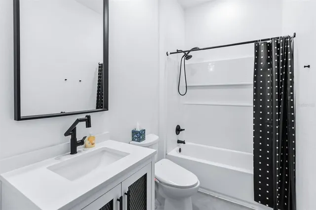 a bathroom with a sink toilet vanity and shower
