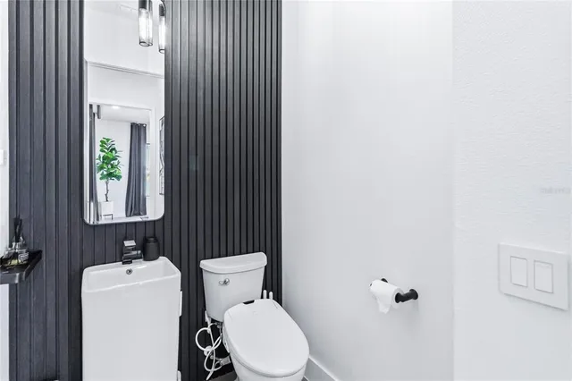 a white toilet sitting next to a bathroom sink