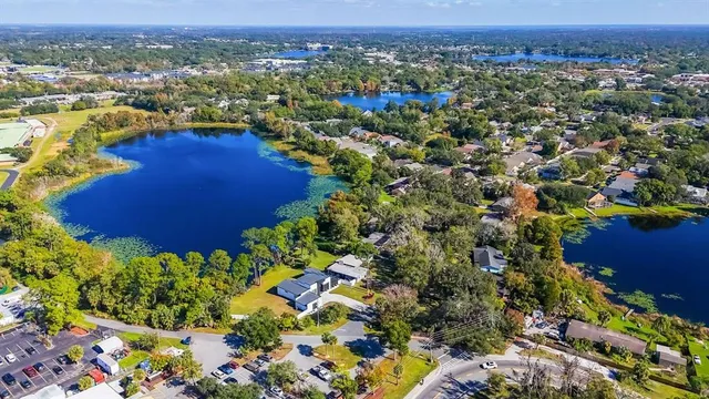 an aerial view of residential houses with outdoor space and trees