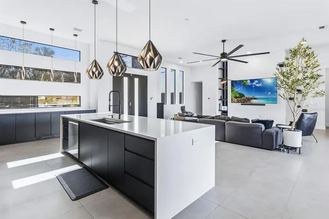 a kitchen with stainless steel appliances granite countertop a sink and a stove