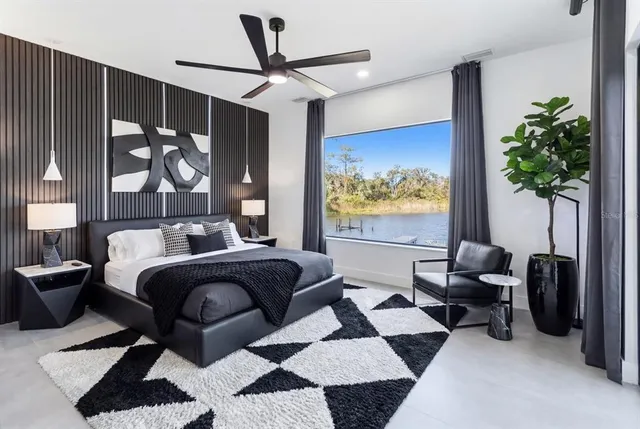a bedroom with a bed and a potted plant