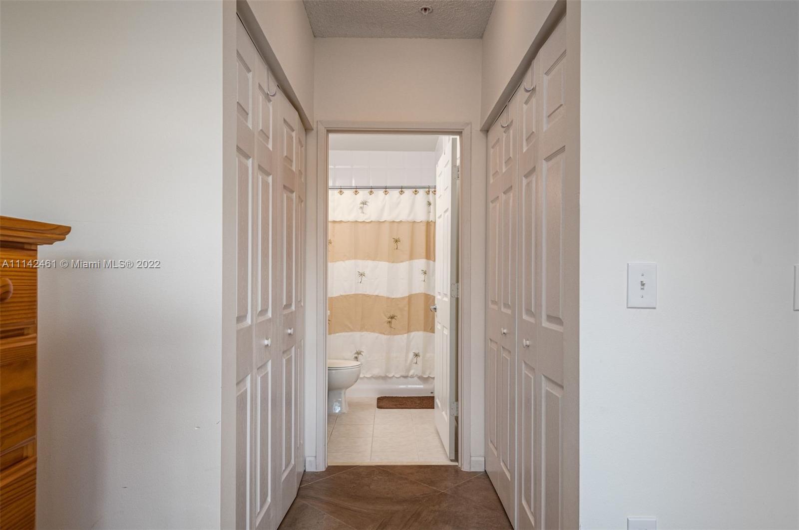 8030 North Nob Hill Road, Unit 306 Tamarac, FL 33321 - Photo 14 of 26 a view of a hallway with a living room