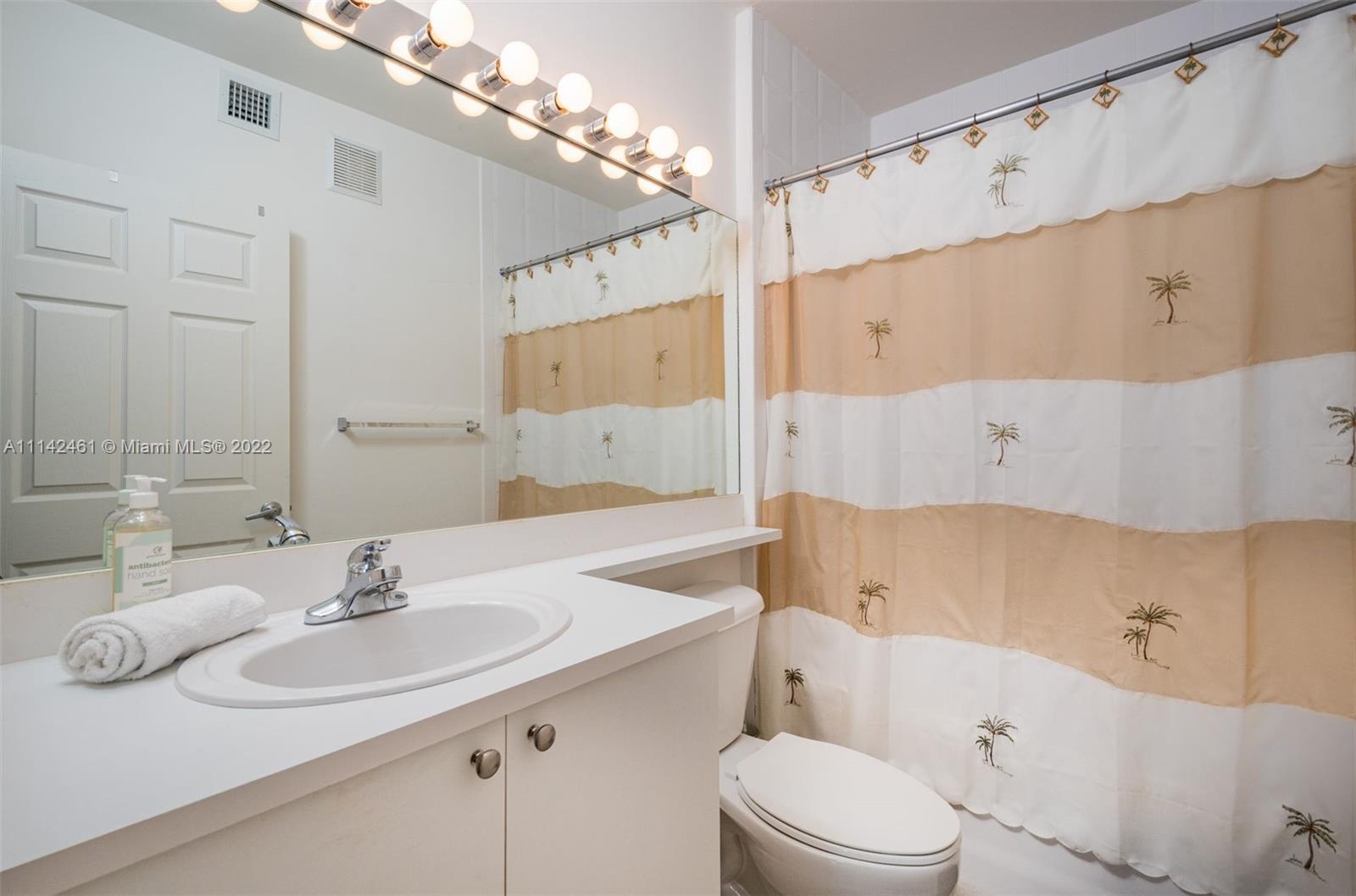 8030 North Nob Hill Road, Unit 306 Tamarac, FL 33321 - Photo 15 of 26 a bathroom with a sink a toilet and shower