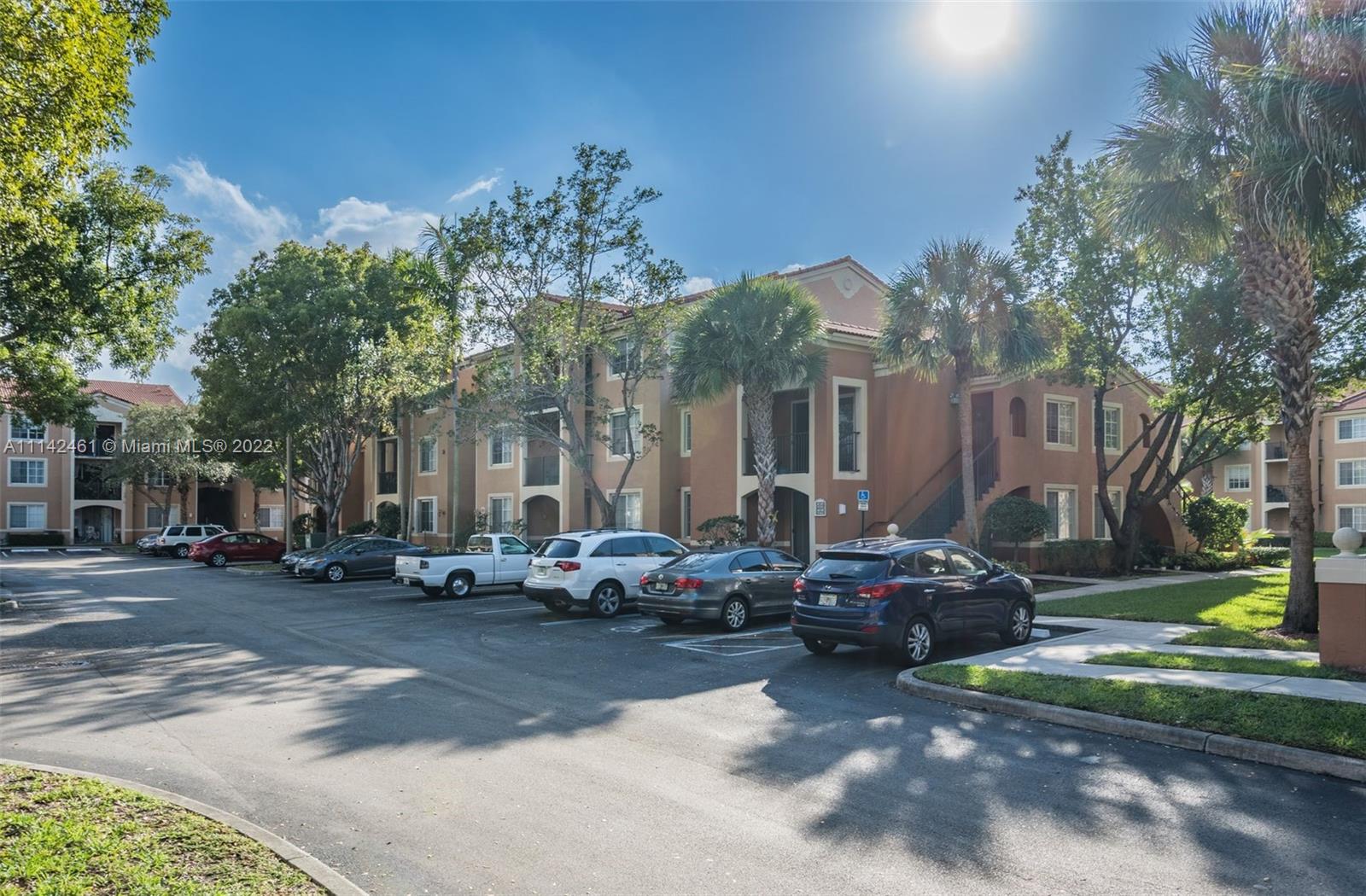 8030 North Nob Hill Road, Unit 306 Tamarac, FL 33321 - Photo 2 of 26 a cars parked on the side of a street