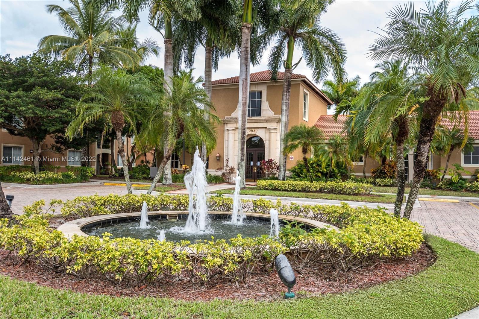 8030 North Nob Hill Road, Unit 306 Tamarac, FL 33321 - Photo 25 of 26 a view of a house with swimming pool and a garden
