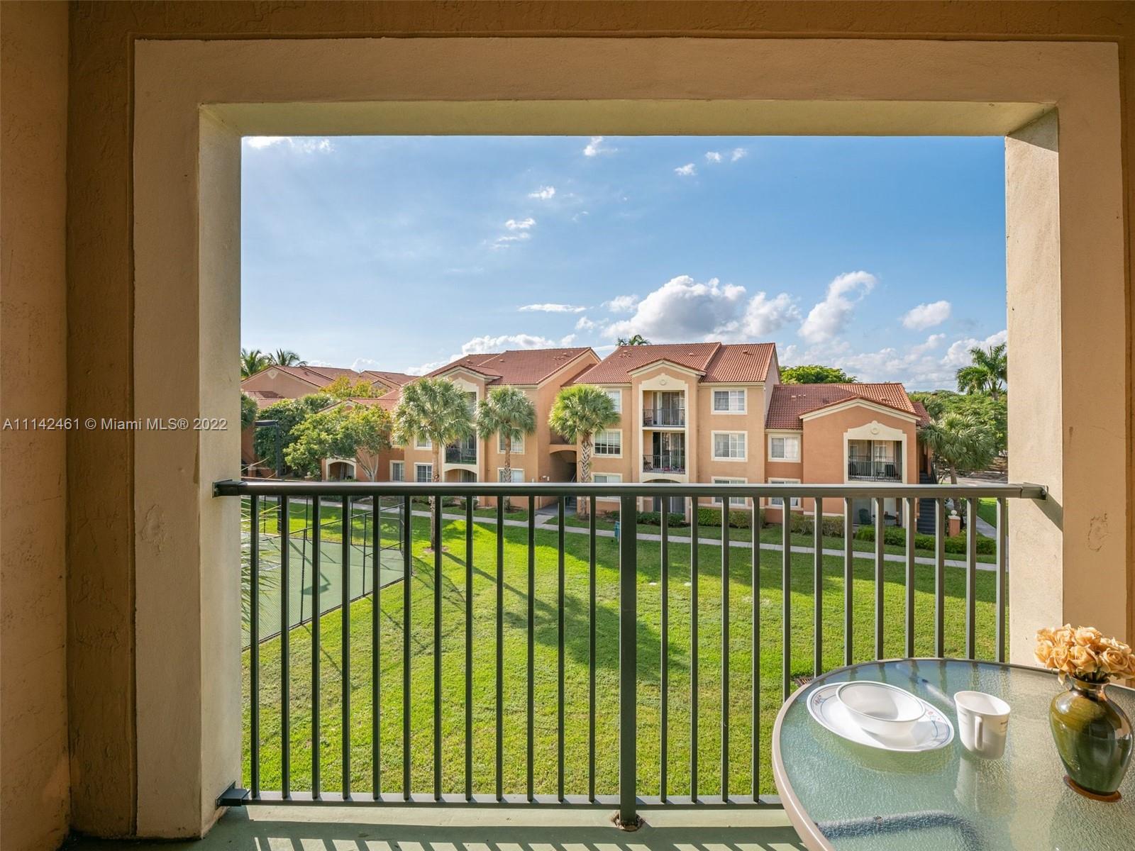 8030 North Nob Hill Road, Unit 306 Tamarac, FL 33321 - Photo 7 of 26 a view of a balcony with a garden