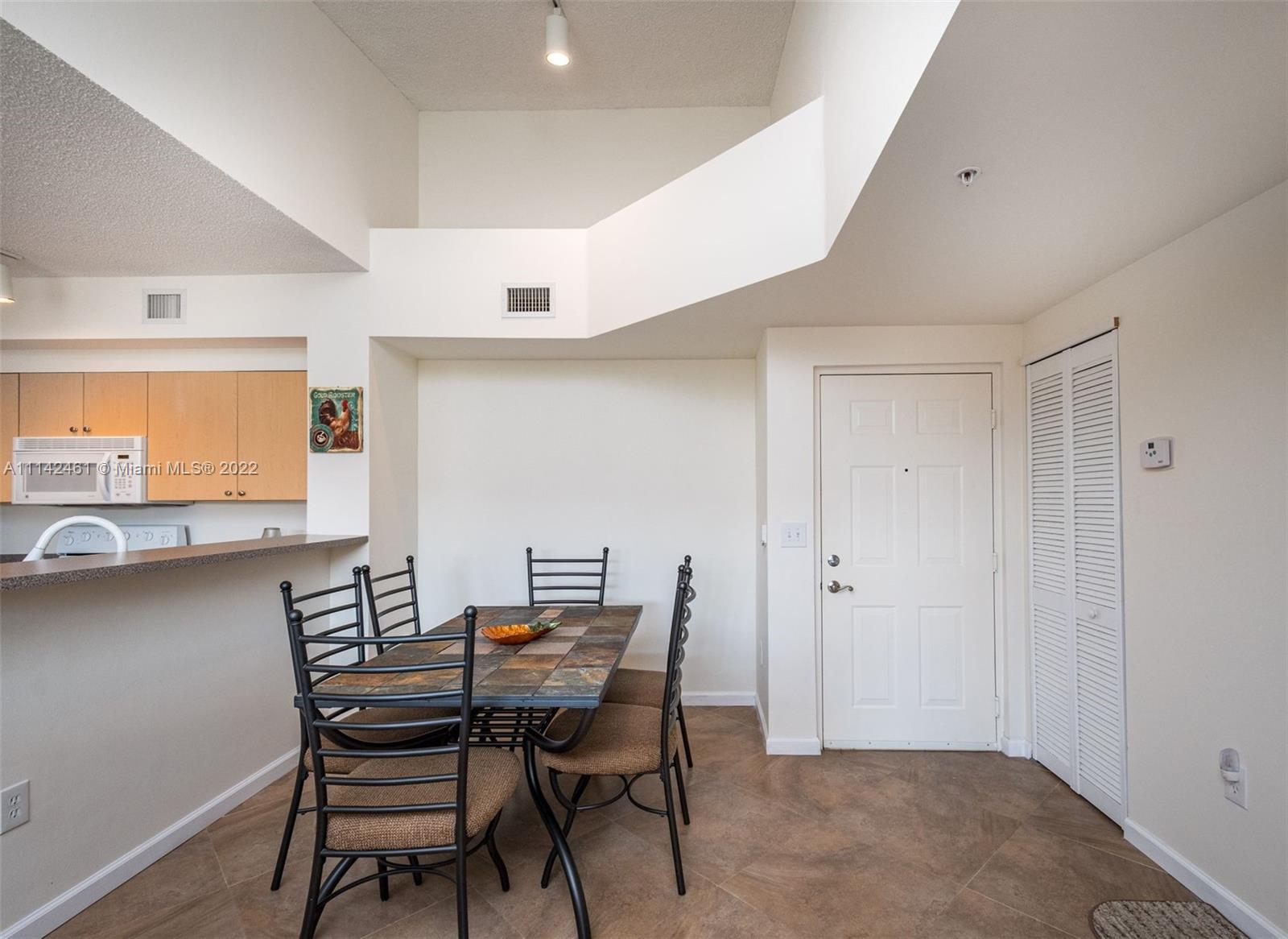 8030 North Nob Hill Road, Unit 306 Tamarac, FL 33321 - Photo 10 of 26 a view of a dining room with furniture and window