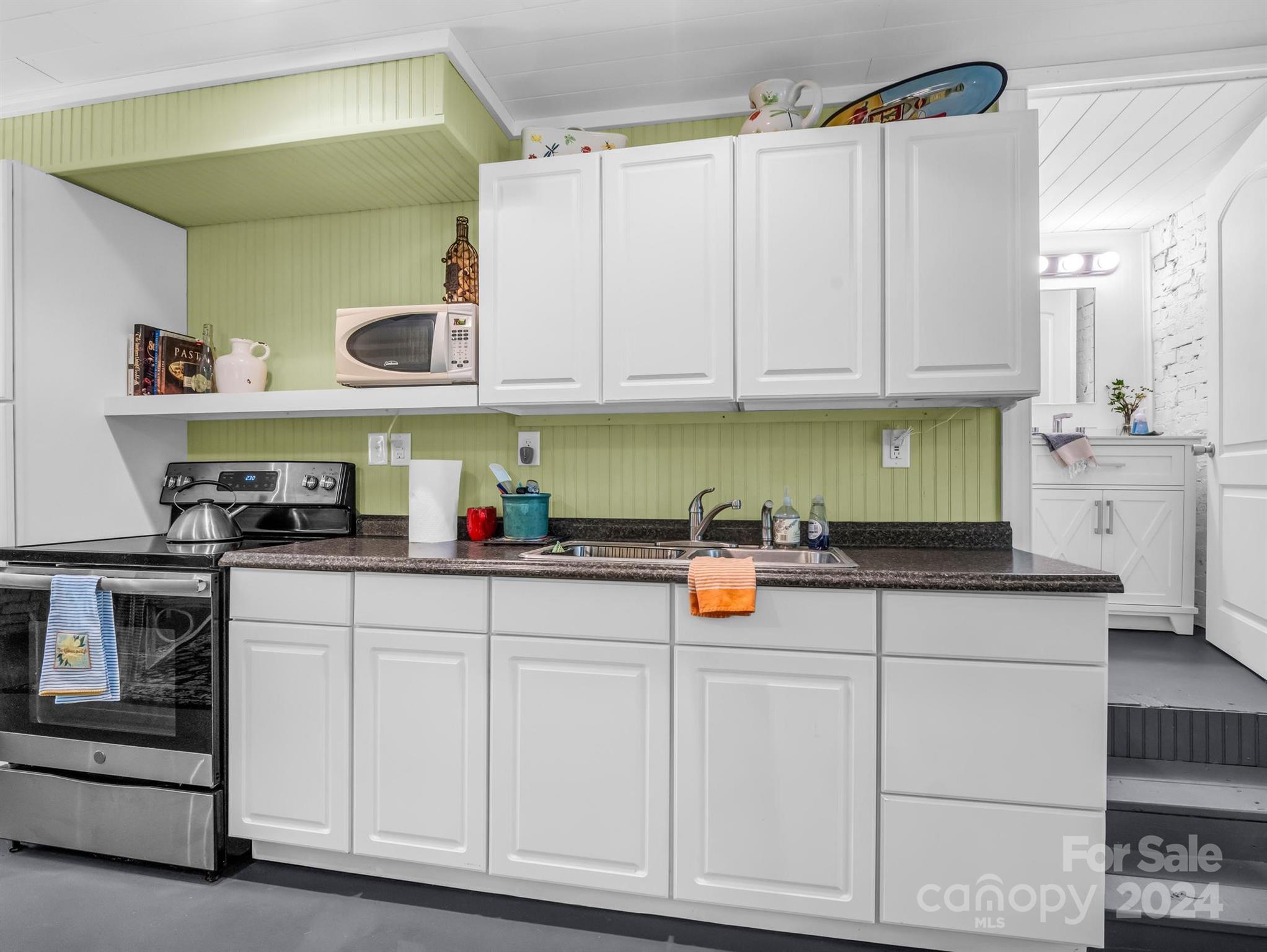 316 North Main Street Rutherfordton, NC 28139 - Photo 11 of 30 a kitchen with white cabinets and white appliances
