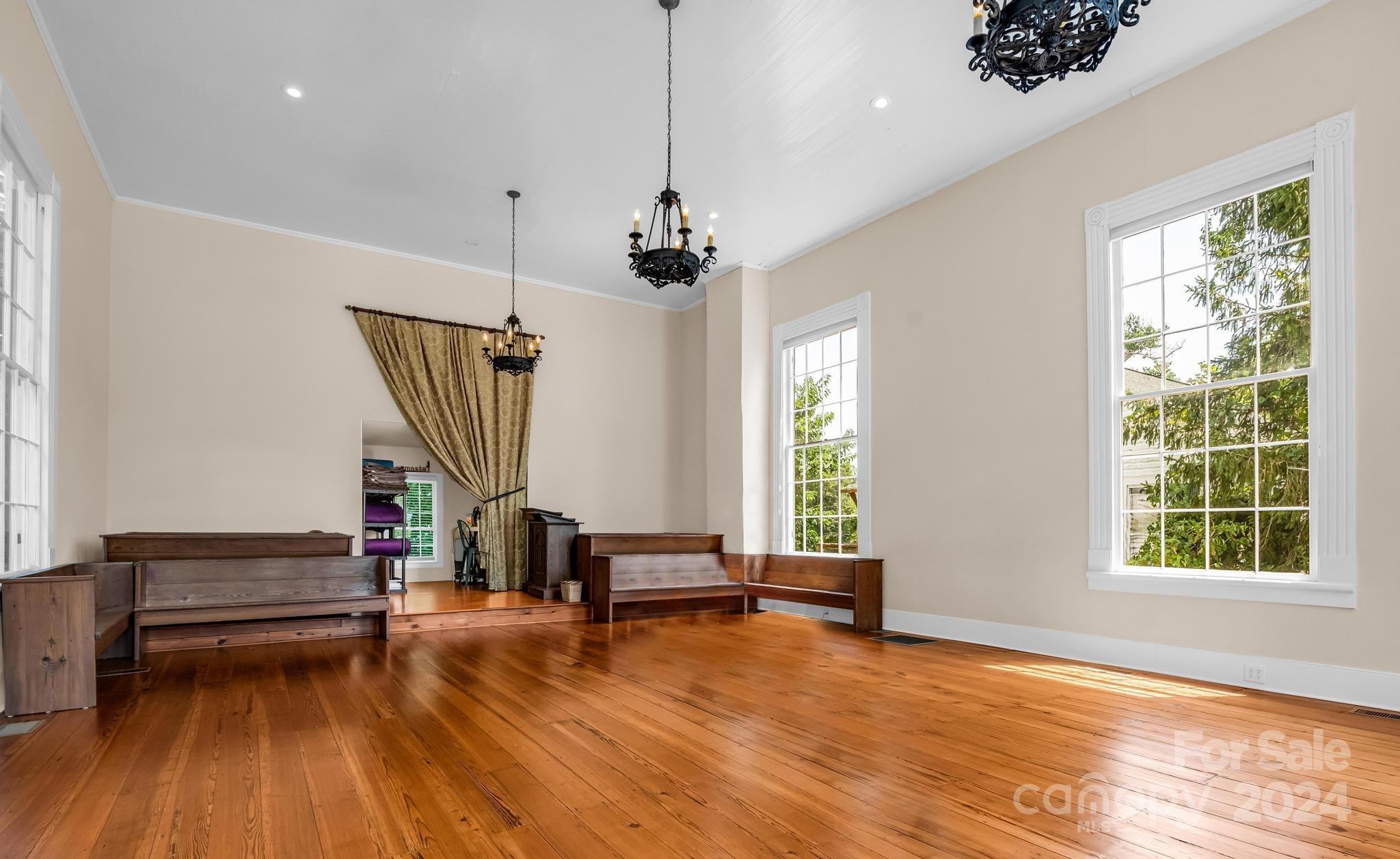 316 North Main Street Rutherfordton, NC 28139 - Photo 6 of 30 a view of room with wooden floor and windows