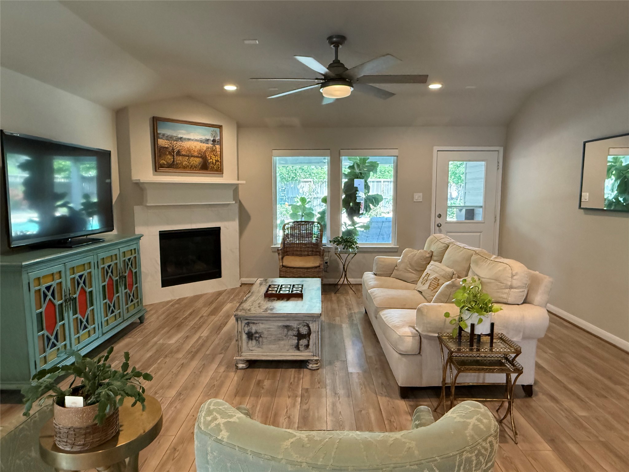 2336 Hagerman Road Conroe, TX 77384 - Photo 26 of 35 a living room with furniture flat screen tv and a fireplace