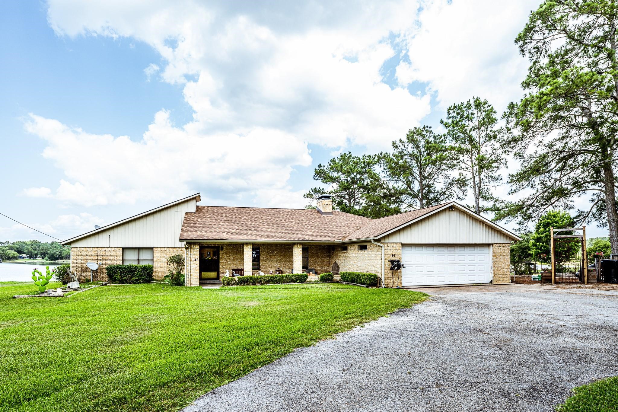 46 Point Loop Huntsville, TX 77320 - Photo 2 of 49 a front view of a house with a yard and garage