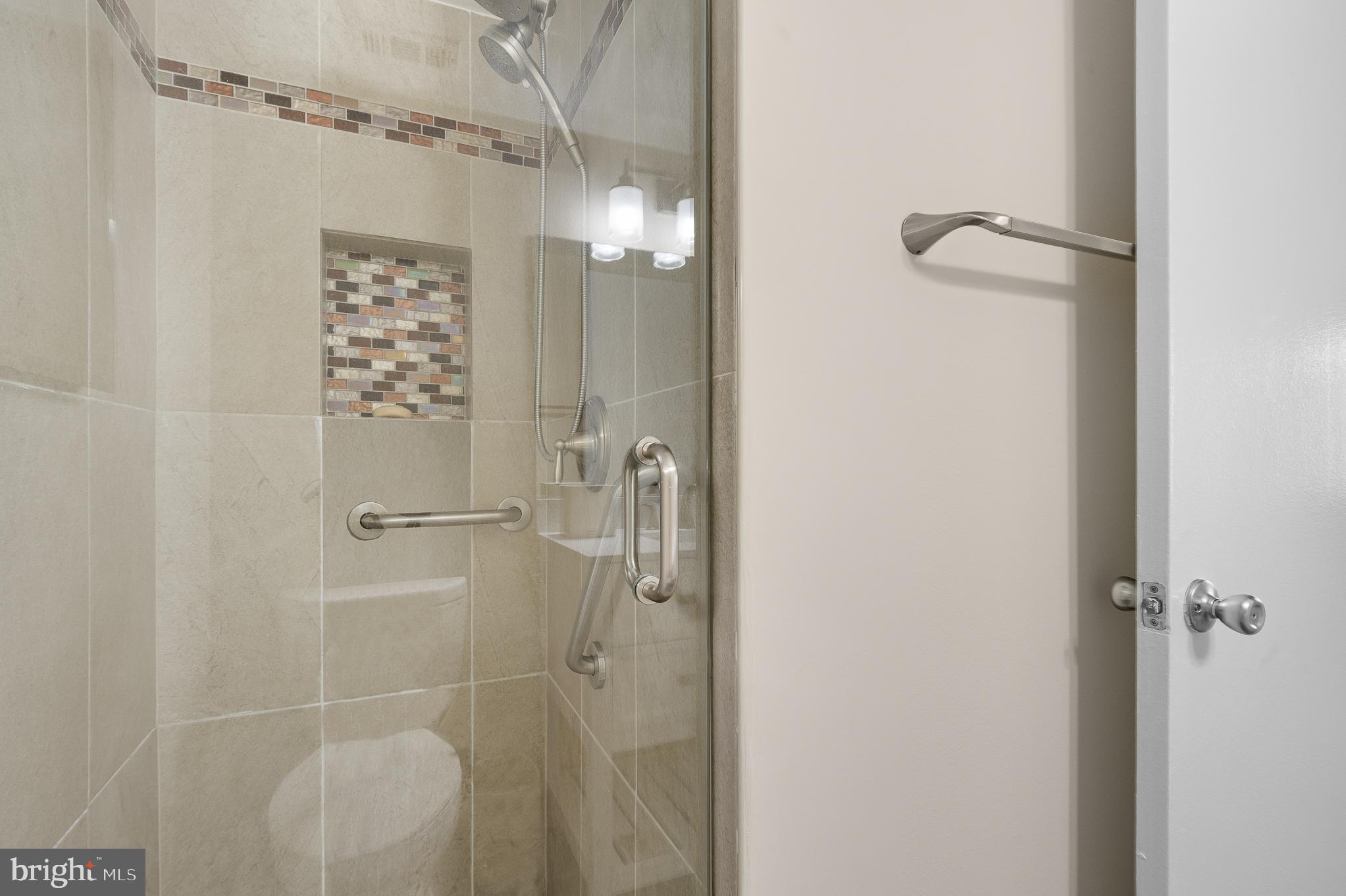 19027 Mills Choice Road, Unit 4 Gaithersburg, MD 20886 - Photo 37 of 41 Sleek modern shower with elegant tile accents.