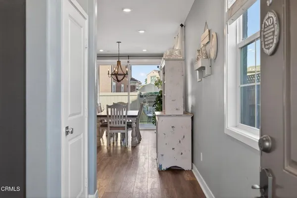 a view of a a dining room with furniture window and wooden floor