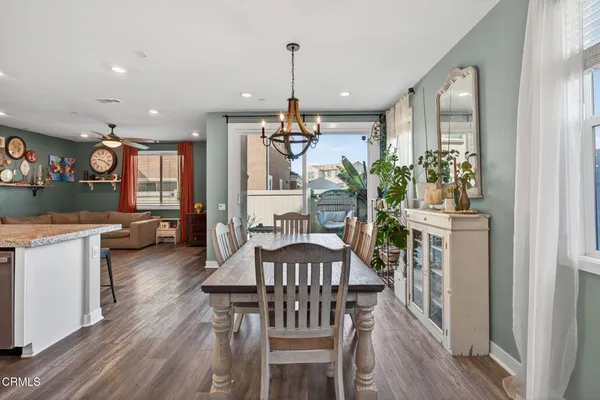 a dining room with furniture and wooden floor