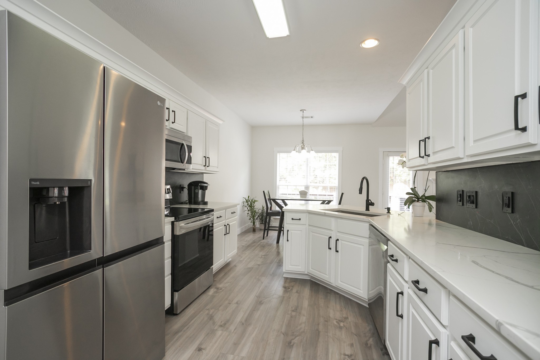7337 Campton Road Nashville, TN 37211 - Photo 15 of 53 a kitchen with granite countertop a refrigerator stove top oven and sink
