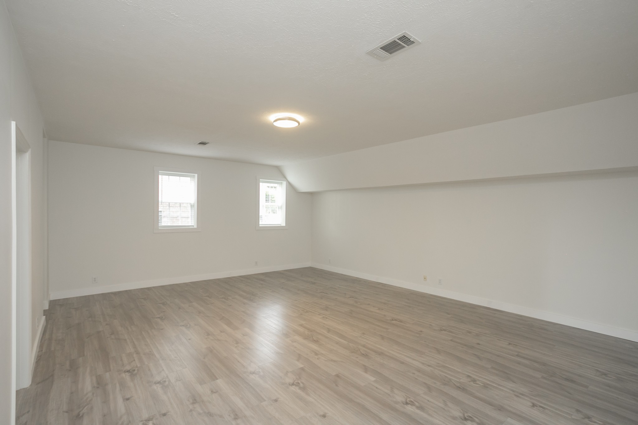 7337 Campton Road Nashville, TN 37211 - Photo 42 of 53 an empty room with wooden floor and windows