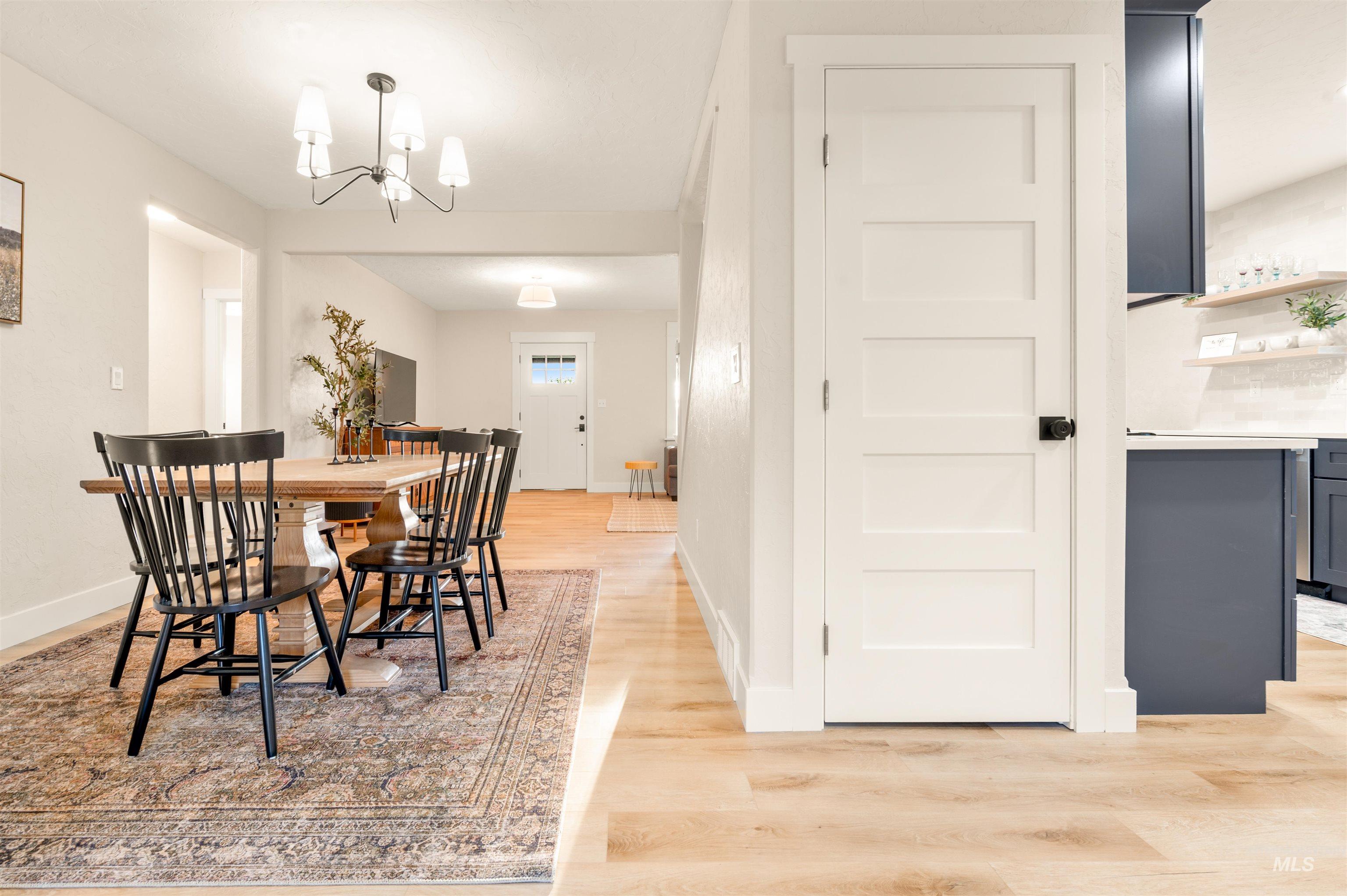 811 Prospect Avenue Lewiston, ID 83501 - Photo 5 of 23 Spacious open-concept living area featuring light wood-finish flooring, a plush carpeted staircase, and a built-in wet bar with dark cabinetry and open shelving