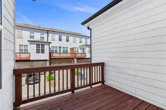 a view of a wooden chairs on the roof deck