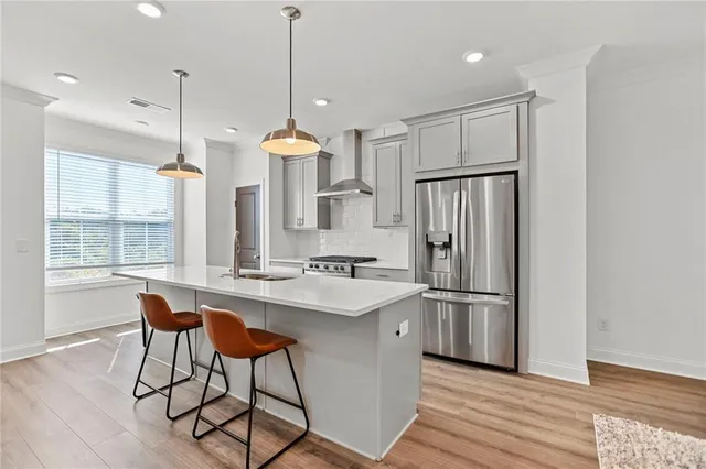 a kitchen with refrigerator cabinets and wooden floor