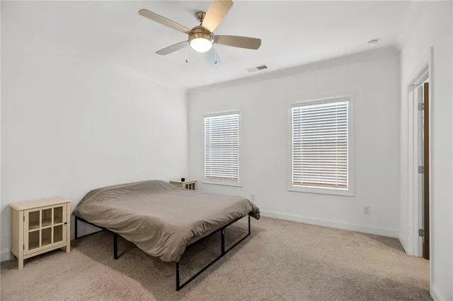 a spacious bedroom with a bed and a window