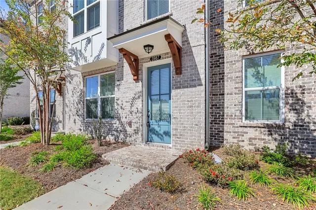 a front view of a house with a garden