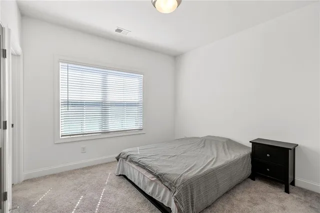 a bedroom with a bed and window