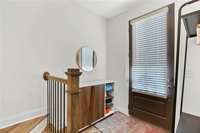 a view of a hallway with entryway wooden floor and front door