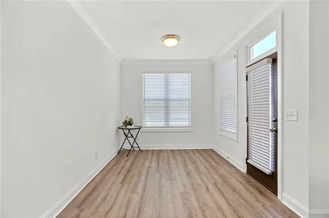 a view of a room with wooden floor and a window