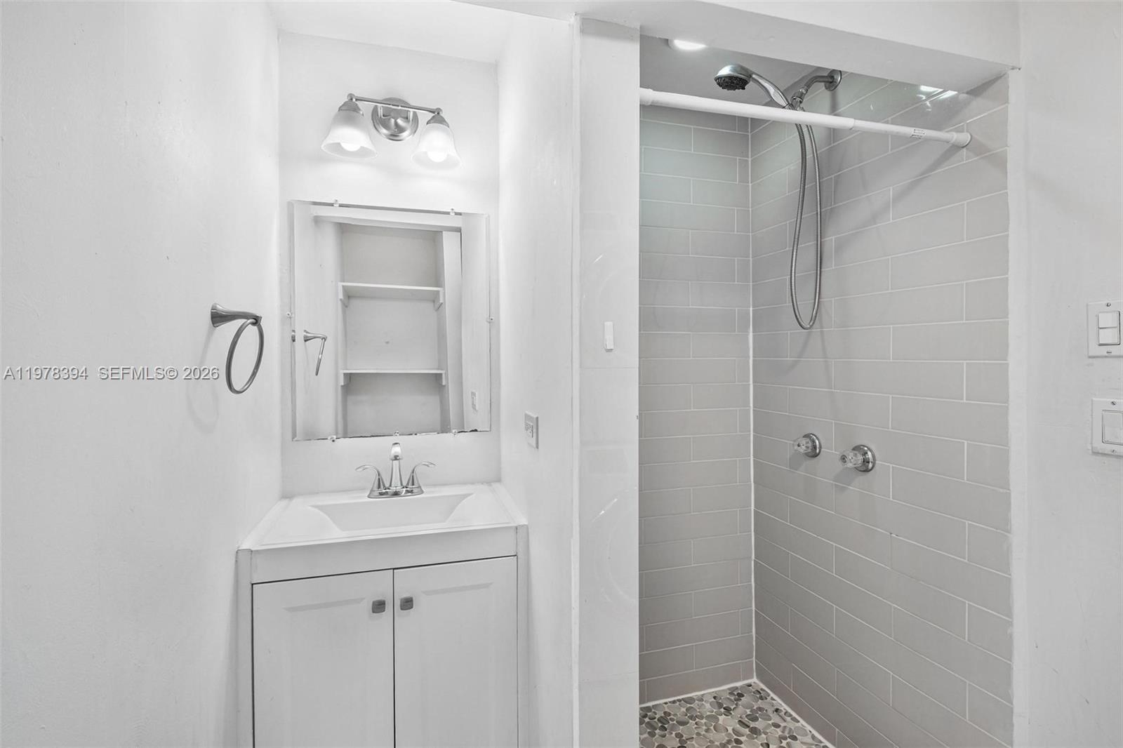 2862 Southwest 38th Court Miami, FL 33134 - Photo 11 of 67 a bathroom with a shower sink and mirror