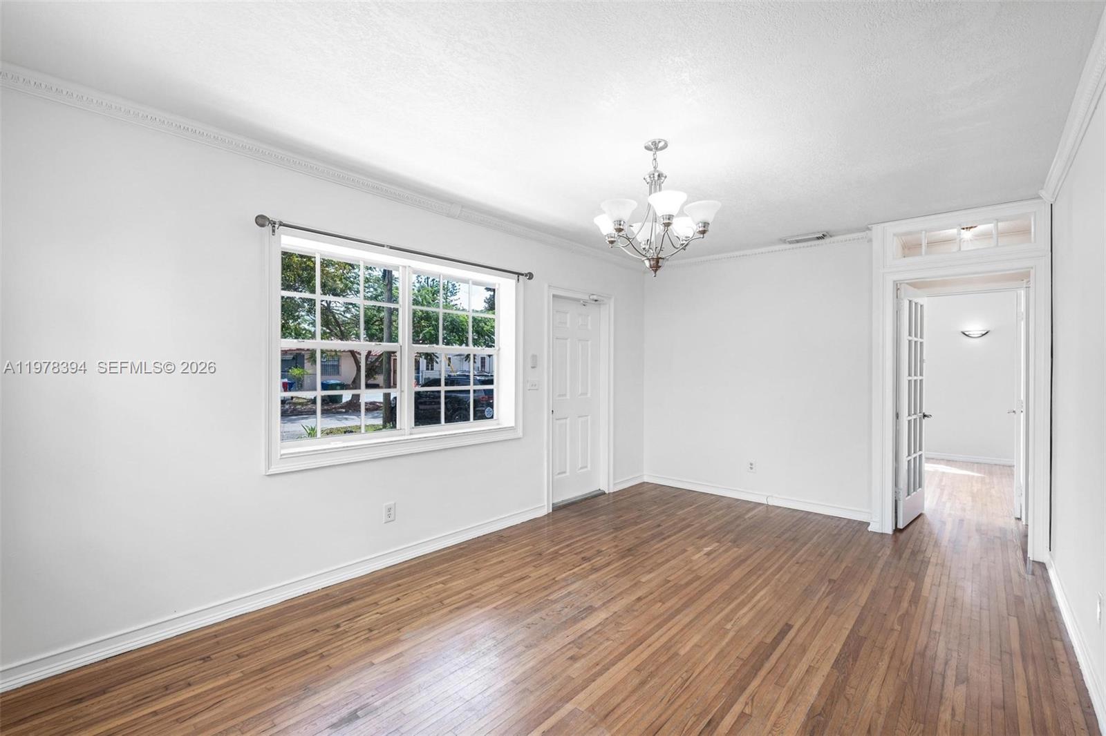 2862 Southwest 38th Court Miami, FL 33134 - Photo 14 of 67 wooden floor in an empty room with a window