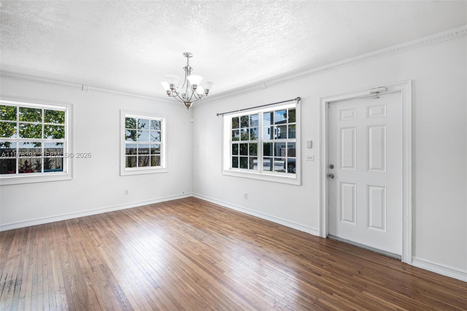 2862 Southwest 38th Court Miami, FL 33134 - Photo 15 of 67 a view of an empty room with wooden floor and windows