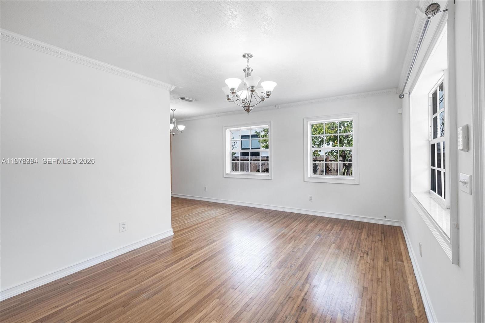 2862 Southwest 38th Court Miami, FL 33134 - Photo 16 of 67 a view of an empty room with wooden floor and a window