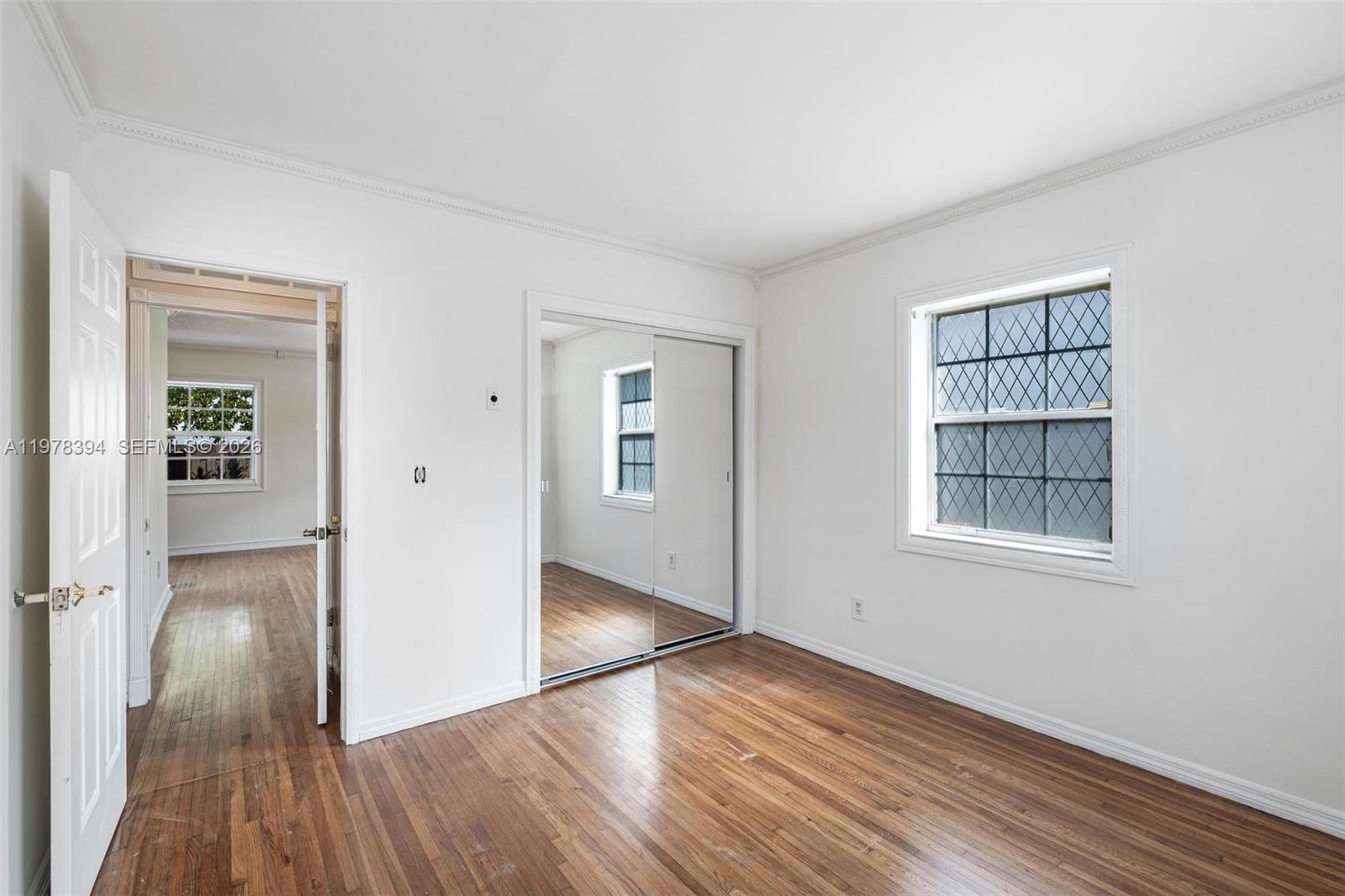 2862 Southwest 38th Court Miami, FL 33134 - Photo 18 of 67 wooden floor in an empty room with a window