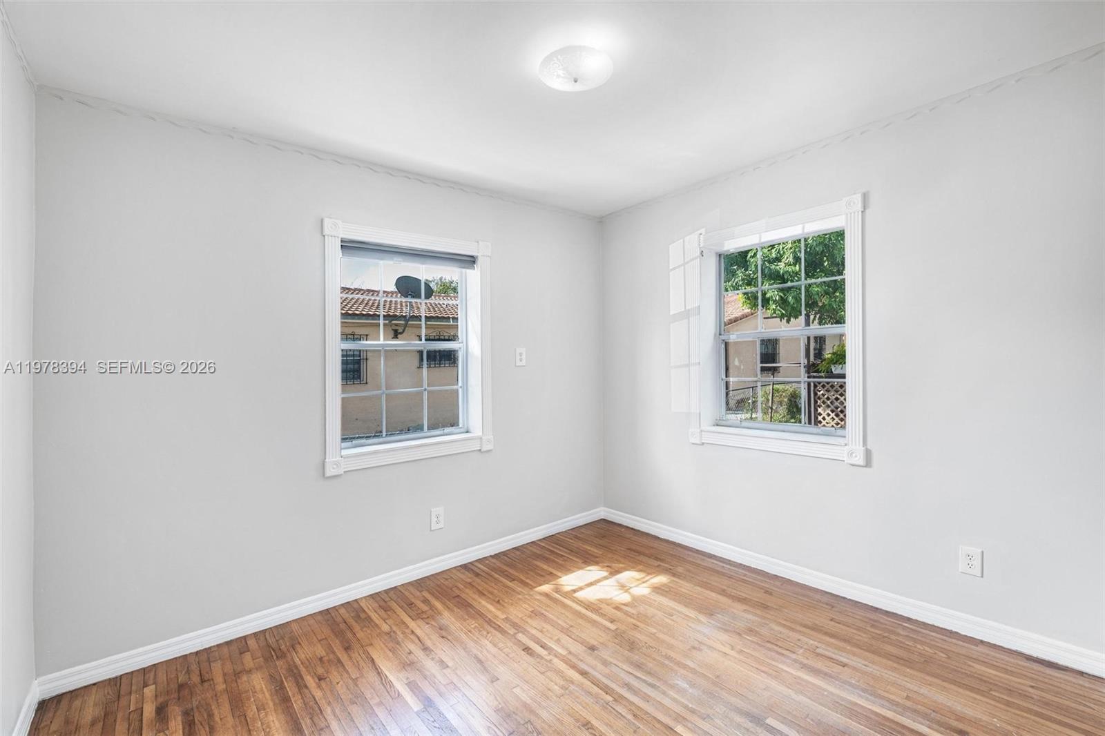 2862 Southwest 38th Court Miami, FL 33134 - Photo 20 of 67 a view of empty room with wooden floor and fan