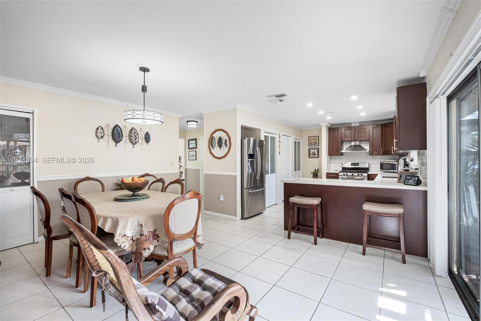 2862 Southwest 38th Court Miami, FL 33134 - Photo 31 of 67 a kitchen with stainless steel appliances kitchen island granite countertop a sink and a refrigerator