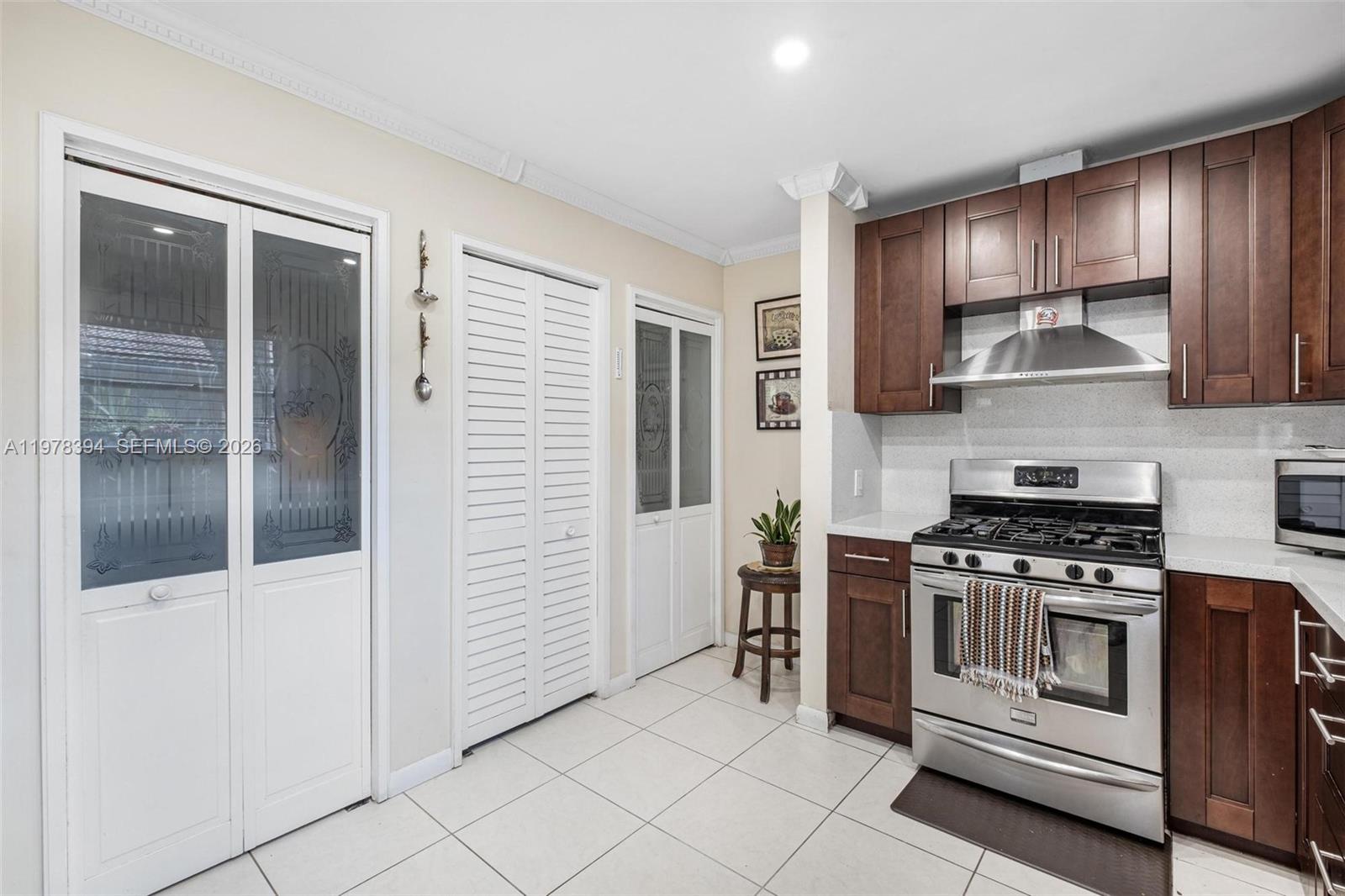 2862 Southwest 38th Court Miami, FL 33134 - Photo 36 of 67 a kitchen with stainless steel appliances granite countertop a stove and a refrigerator