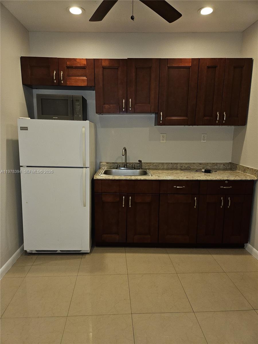 2862 Southwest 38th Court Miami, FL 33134 - Photo 47 of 67 a kitchen with a cabinets and a refrigerator
