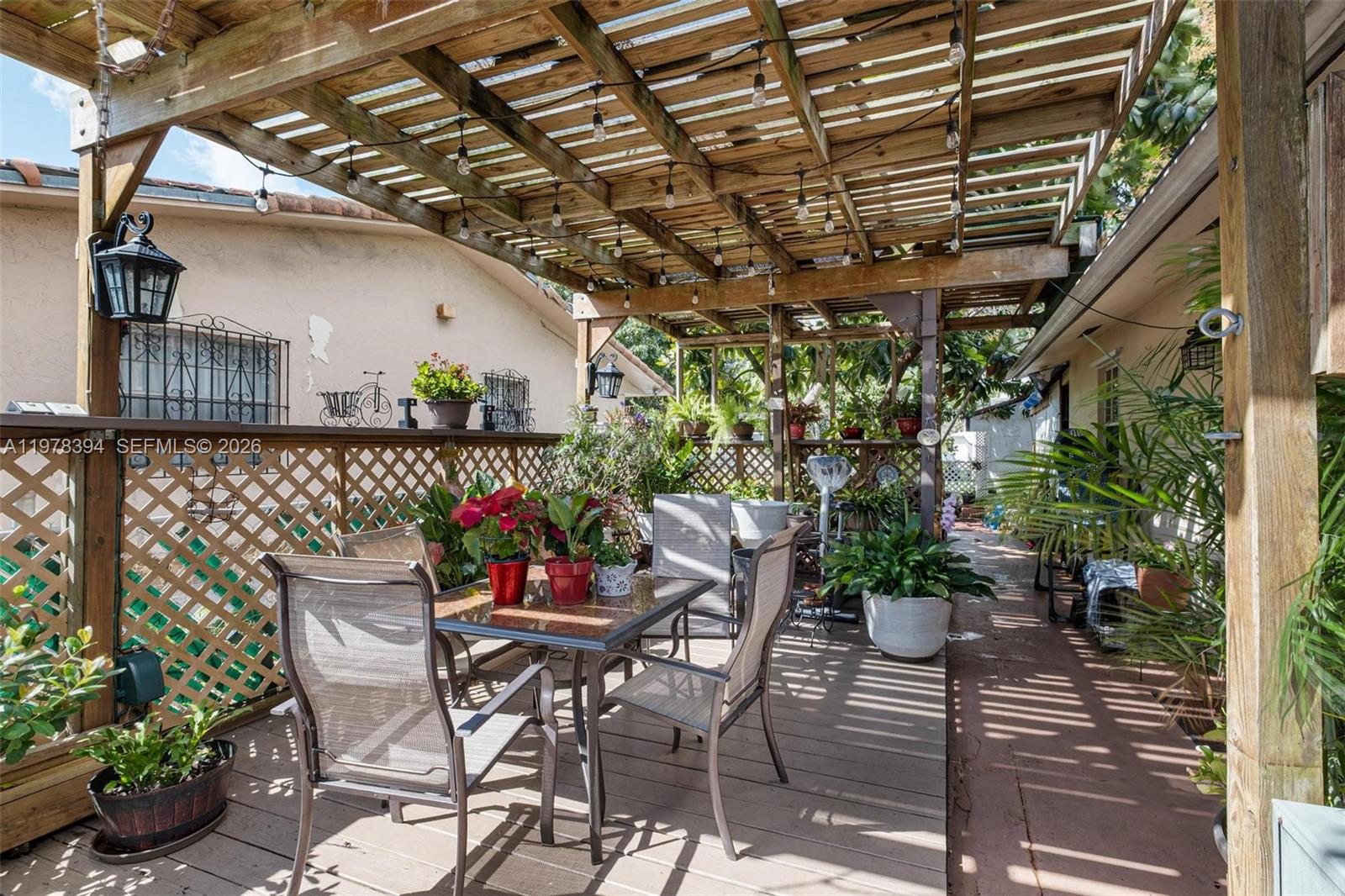 2862 Southwest 38th Court Miami, FL 33134 - Photo 54 of 67 a patio with table and chairs and potted plants