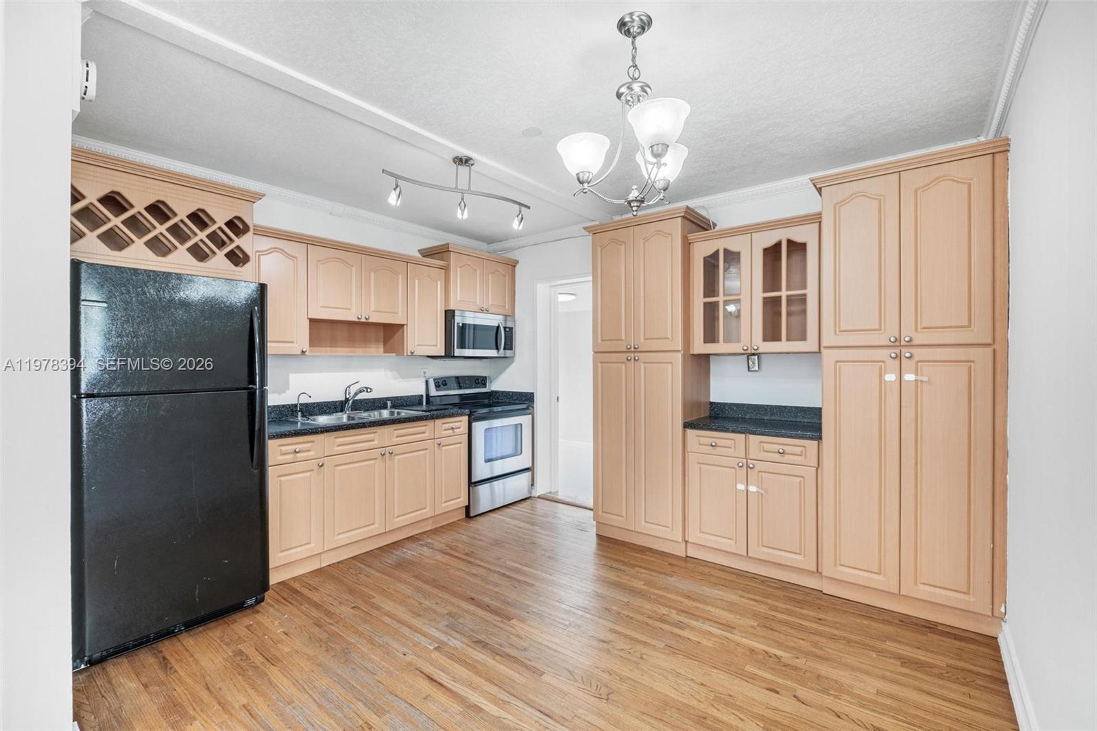 2862 Southwest 38th Court Miami, FL 33134 - Photo 6 of 67 a kitchen with stainless steel appliances granite countertop a refrigerator and a stove top oven