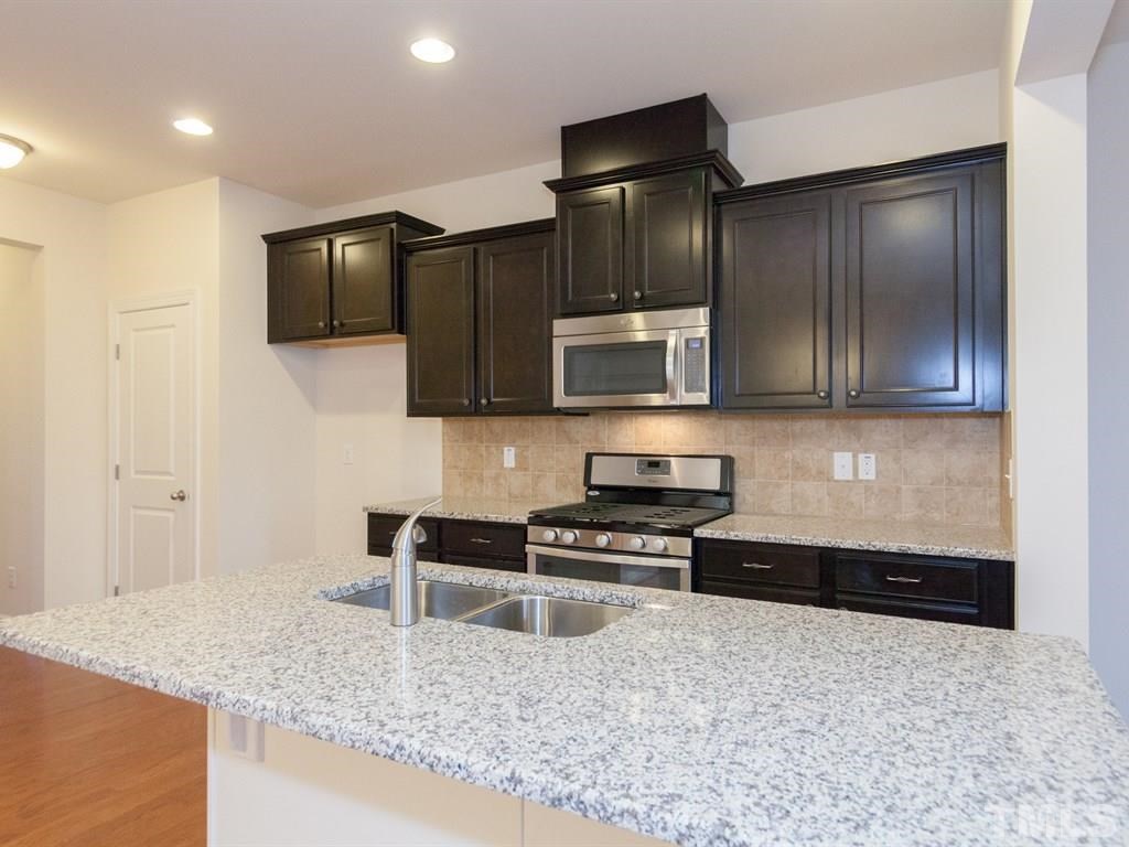 2424 Pecan Ridge Way Apex, NC 27502 - Photo 4 of 21 Granite is standard in our homes! Not actual Home. Pictures are of same floorplan in community