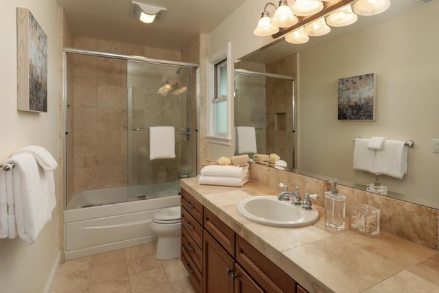 an aerial view of a house with garden space and sitting area