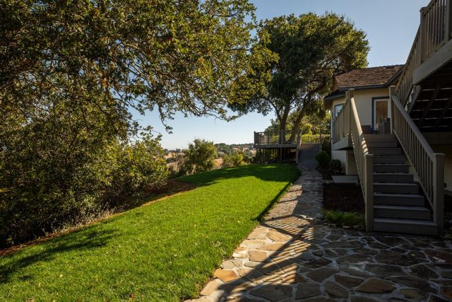 a front view of a house with a garden