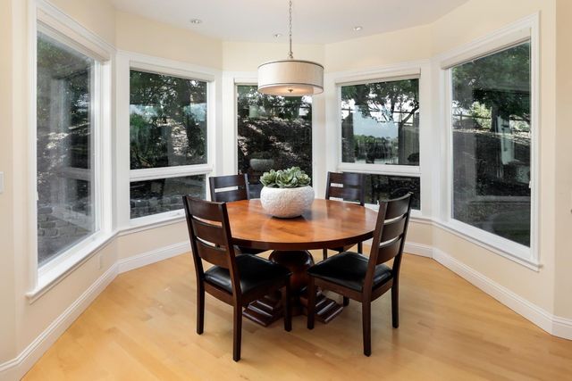 a dining room with furniture and wooden floor